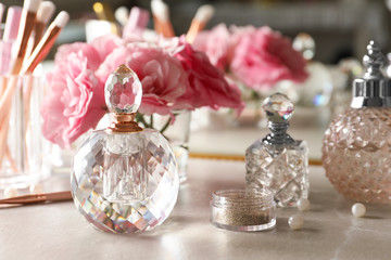 Obraz na płótnie Canvas Different elegant perfume bottles on dressing table