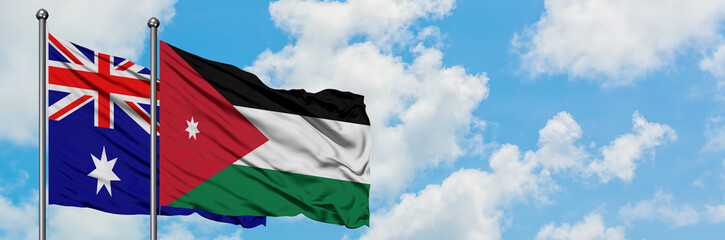 Australia and Jordan flag waving in the wind against white cloudy blue sky together. Diplomacy concept, international relations.