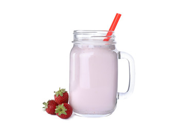 Tasty fresh milk shake in mason jar with strawberries on white background