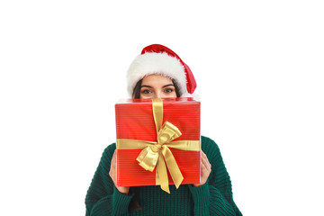 Happy young woman in Santa hat with Christmas gift on white background