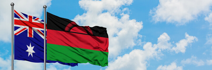 Australia and Malawi flag waving in the wind against white cloudy blue sky together. Diplomacy concept, international relations.