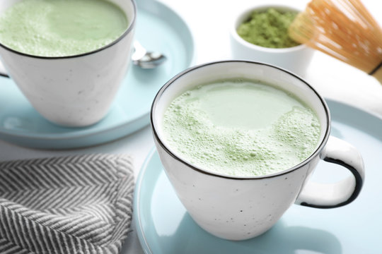 Tasty matcha green tea latte on white table, closeup