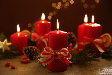 Beautiful Christmas composition with burning candle on wooden table against blurred lights