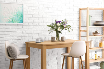 Stylish room interior with wooden dining table