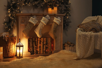 Fireplace with Christmas stockings in festive room interior