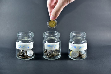 Hand holding Coin money and Choice jar bottle concept Saving money Investment for Family Future plan