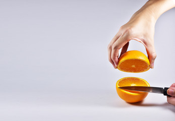 Hand holding Slicing knives slice Orange white background