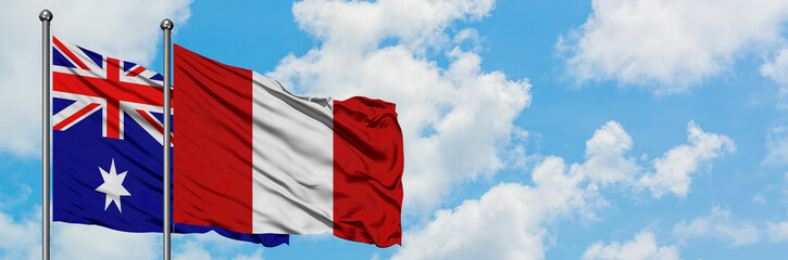 Australia and Peru flag waving in the wind against white cloudy blue sky together. Diplomacy concept, international relations.