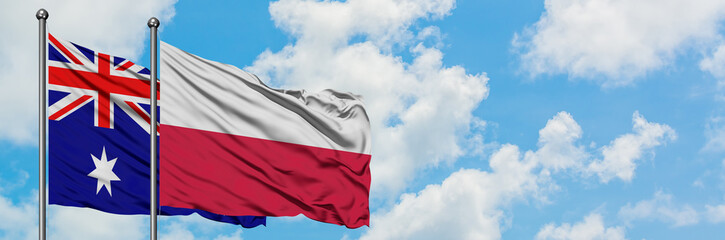 Fototapeta na wymiar Australia and Poland flag waving in the wind against white cloudy blue sky together. Diplomacy concept, international relations.