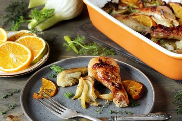 dish with fennel. Baked chicken drumsticks with fennel and oranges. festive dish, popular in the Mediterranean. Keto diet dish. ceramic baking dish.