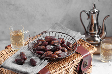 dates fruit and Arab tea on a white concrete background with a blank space for a text, dates fruit on a white background