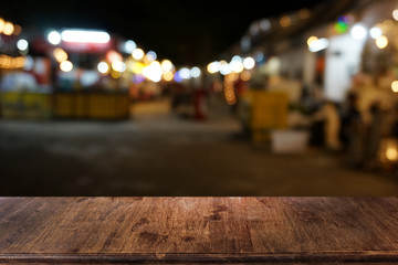Empty dark wooden table in front of abstract blurred bokeh background of restaurant . can be used for display or montage your products.Mock up for space.