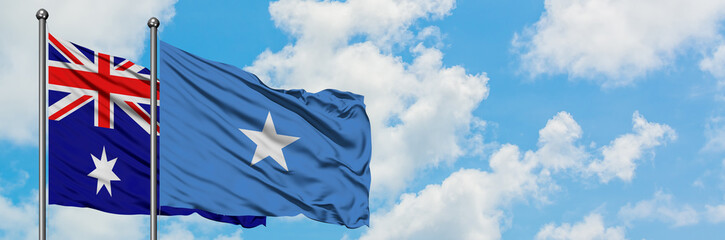Fototapeta premium Australia and Somalia flag waving in the wind against white cloudy blue sky together. Diplomacy concept, international relations.