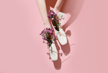 Comfortable women's shoes with flowers on a pastel background. Creative concept of fresh smell in shoes, healthy feet, summer sales. 
