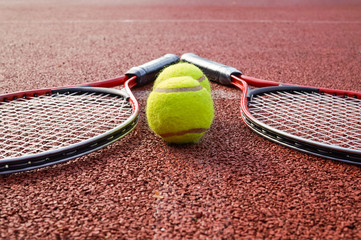 Low angle view tennis scene with balls and racquet
