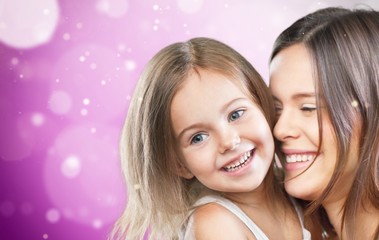 Mother and Baby kissing and hugging at Home. Happy Smiling Family Portrait. Mom and Her Child Having Fun together