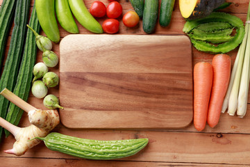 Thai kitchen. Various vegetables, spices  and Ingredients with blank note page and pencil on wooden background. Top view with copy space