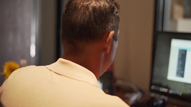 Man working at computer using software to run his business in office