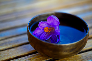 Tibetan singing bowl on a wooden table. - Image