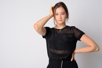 Portrait of young beautiful woman looking at camera and posing