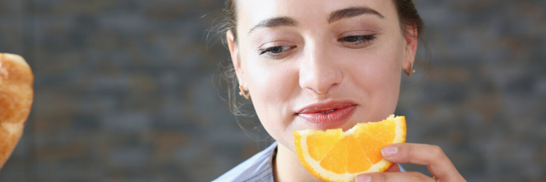 Beautiful Brunette Smiling Woman Eat Sliced Orange