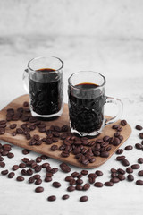 Coffee in cup and coffee beans on rustic table with a blank space for a text, Espresso in cup on white background
