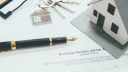 House model with real estate agent and customer discussing for contract to buy house, insurance or loan real estate background.