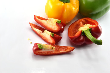 Closeup  fresh  Red, Yellow, Green, bell pepper or sweet pepper or capsicum  isolate sliced on  white background ,raw food ingredient concept.
