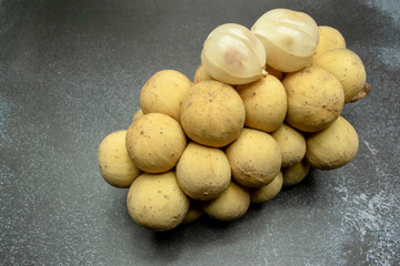 Closeup longkong or wollongong  Thailand fruit on dark tone background with selective focus.