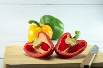 Closeup  fresh  Red, Yellow, Green, bell pepper or sweet pepper or capsicum  isolate slice on  chopping wood on white background ,raw food ingredient concept.