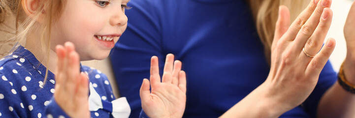 Cute little girl play with mom pat-a-cake