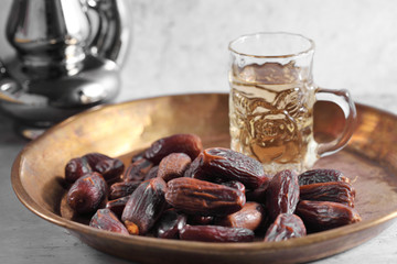 dates fruit and Arab tea on a white concrete background with a blank space for a text, dates fruit on a white background
