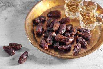 dates fruit and Arab tea on a white concrete background with a blank space for a text, dates fruit on a white background