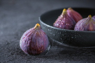 Close up view of fresh figs on dark background