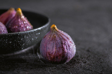 Close up view of fresh figs on dark background