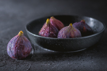 Close up view of fresh figs on dark background