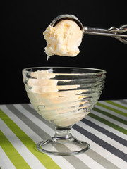 Scooping ice cream into bowl