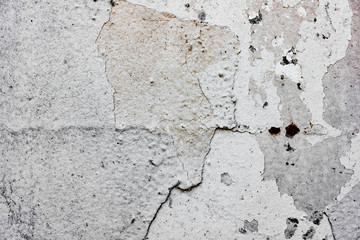 Texture of a concrete wall with cracks and scratches which can be used as a background
