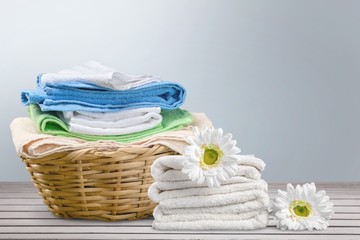 Laundry Basket with colorful towels on background