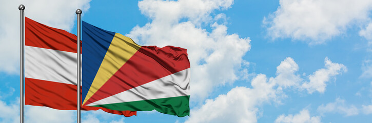 Austria and Seychelles flag waving in the wind against white cloudy blue sky together. Diplomacy concept, international relations.