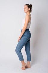 Full body shot profile view of young beautiful woman looking up