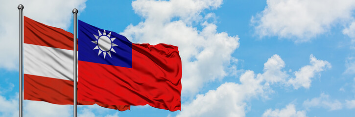 Naklejka premium Austria and Taiwan flag waving in the wind against white cloudy blue sky together. Diplomacy concept, international relations.
