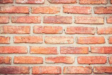 Orange brick wall concrete or stone texture background, wallpaper limestone abstract to flooring and homework/Brickwork or stonework clean grid uneven interior rock old. Copy space.