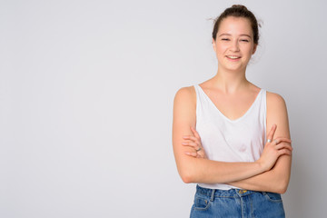 Portrait of happy young beautiful woman smiling with arms crossed