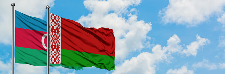 Azerbaijan and Belarus flag waving in the wind against white cloudy blue sky together. Diplomacy concept, international relations.