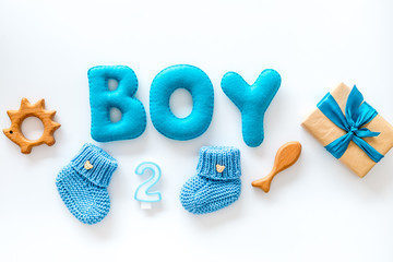 Boy's birthday concept. Set in blue colors with gift box on white backgound top viewcopy space