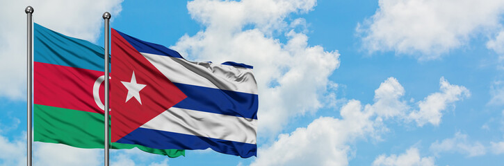 Azerbaijan and Cuba flag waving in the wind against white cloudy blue sky together. Diplomacy concept, international relations.