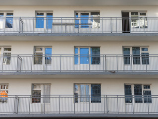 A fragment of the wall of a residential building under construction. Windows and balconies. The...