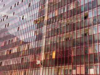 Glass wall of a large residential building. The theme of an emerging housing market under...