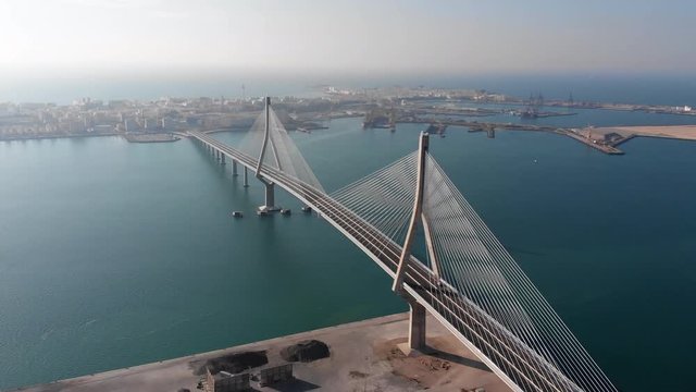 drone view of beautiful white bridge connecting the city of Cadiz.